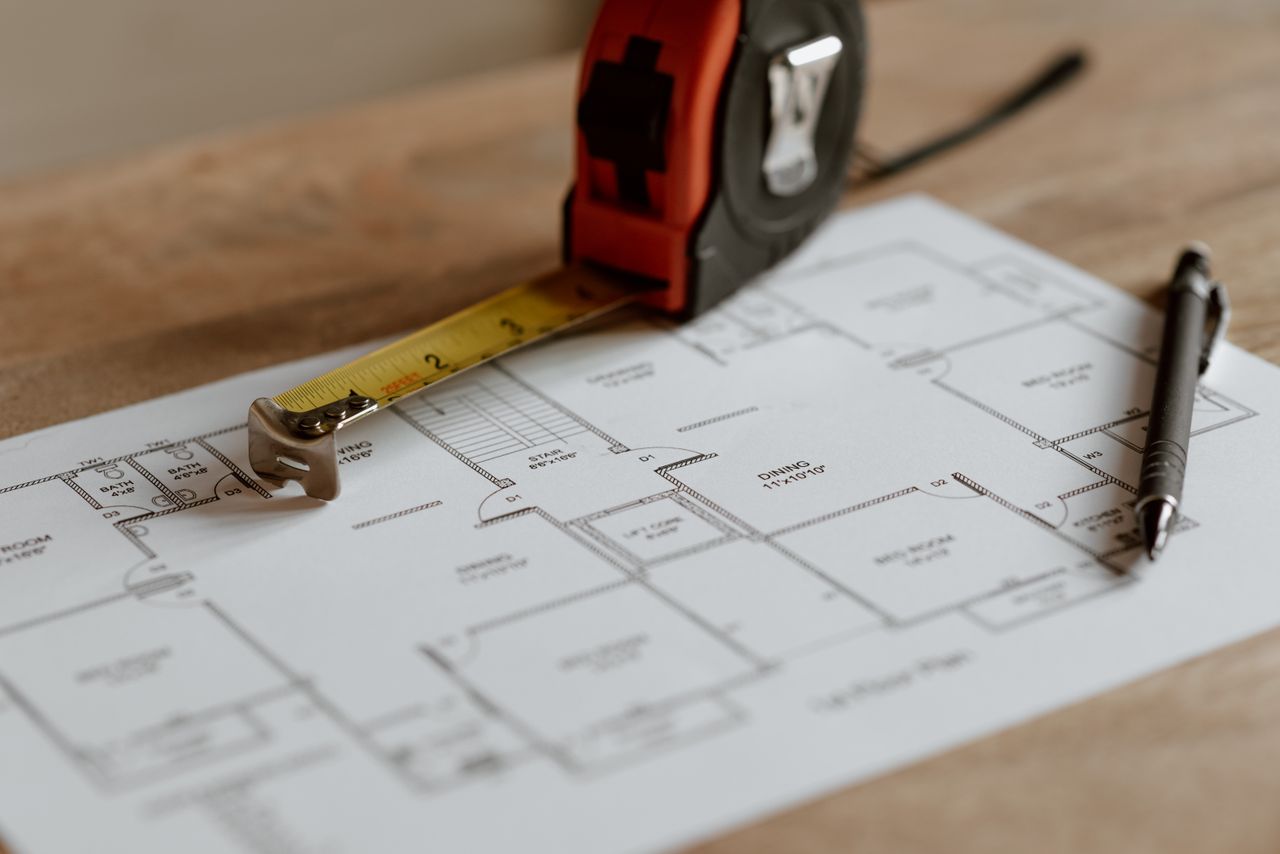 Crafting Captivating Headlines: Your awesome post title goes here From above of ruler placed near pencil on engineering plan of house during renovation process