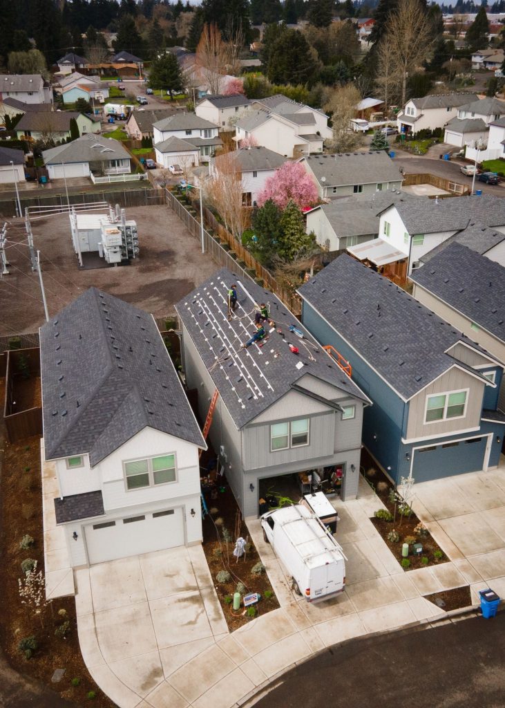 pexels photo 20269502 20269502 Drone shot of workers installing new roof panels in a suburban neighborhood.
