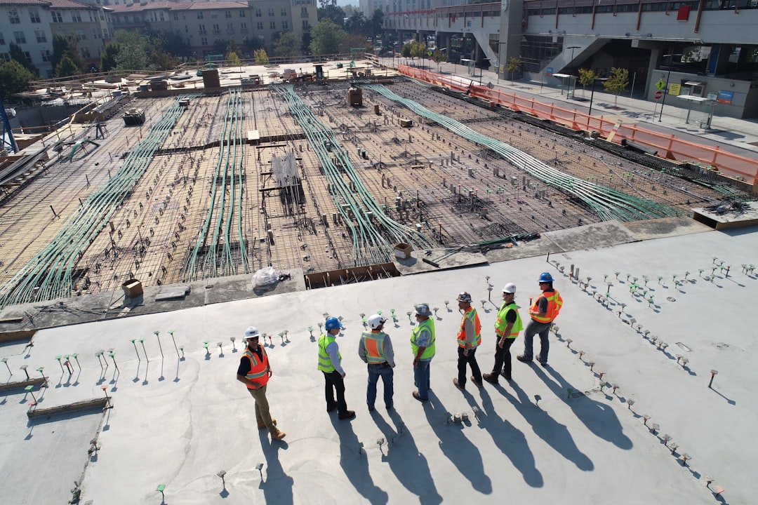 ours-journey seven-construction-workers-standing-on-white-field-x-ghf9ljrvg